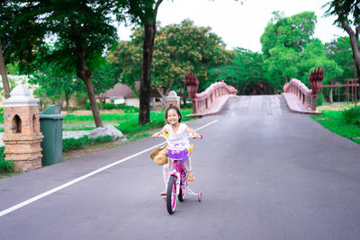 Portrait of girl riding motorcycle on road