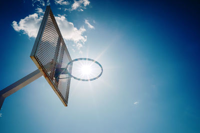 Low angle view of crane against sky on sunny day