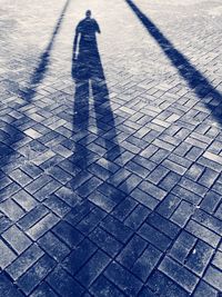 Shadow of person on footpath