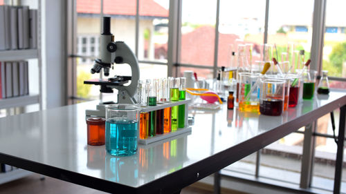 Close-up of objects on glass table