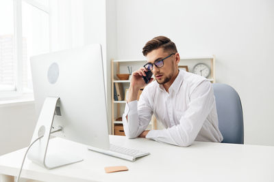 Businessman talking on phone at office