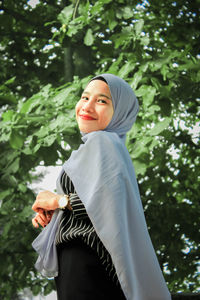 Woman standing against plants