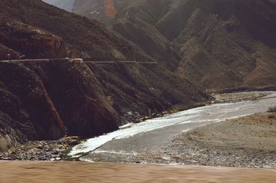 Scenic view of sea by mountains