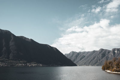 Scenic view of sea and mountains against sky