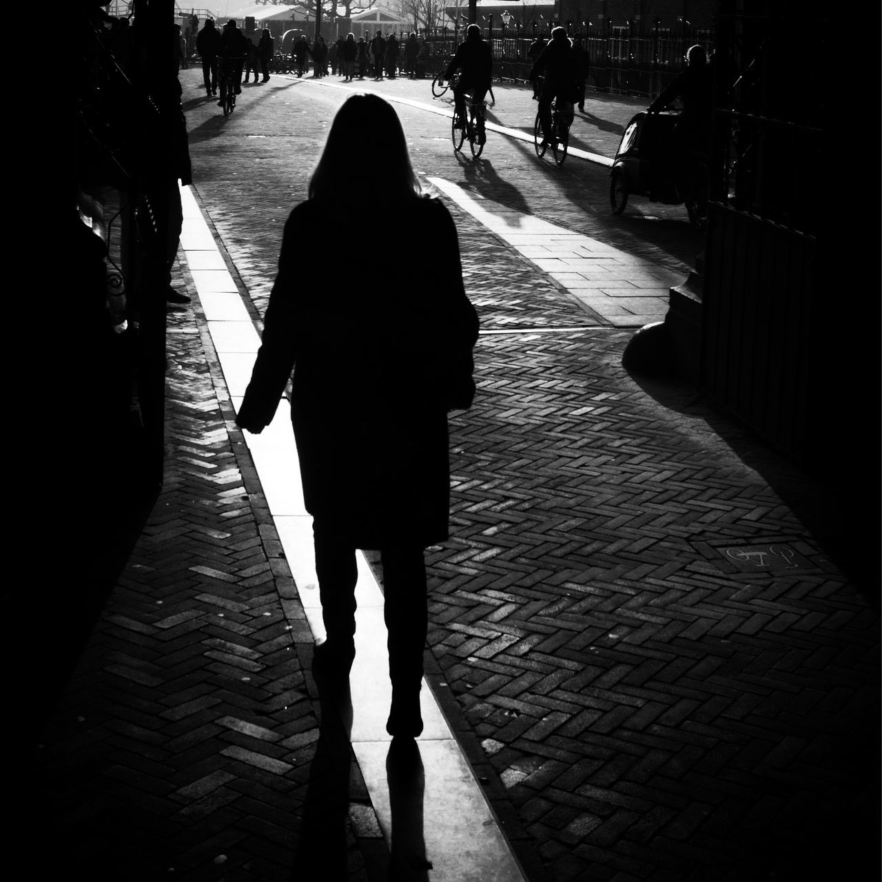 walking, real people, lifestyles, women, leisure activity, sidewalk, full length, silhouette, outdoors, men, day, city, pedestrian, low section, adult, people
