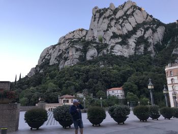 People at historic building against sky