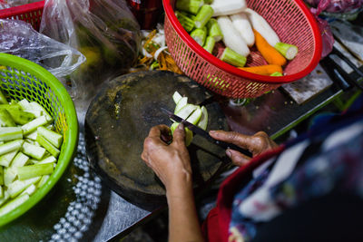 Cropped hand of person preparing food