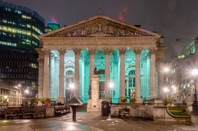 Statue of illuminated building at night