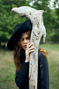 Rear view of woman standing against trees