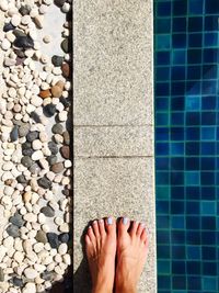 Low section of woman standing on poolside