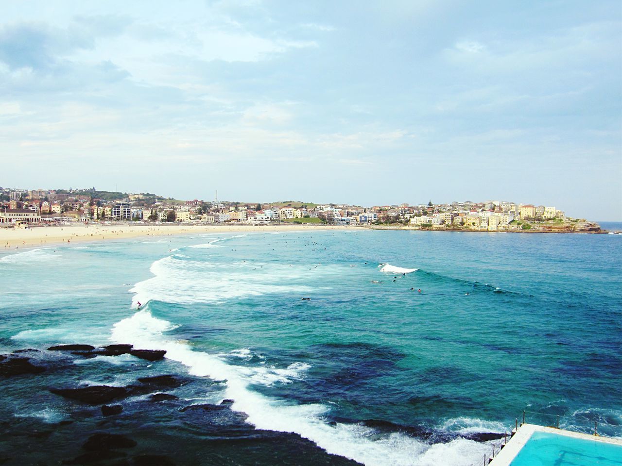 sea, water, sky, blue, building exterior, scenics, built structure, beach, beauty in nature, architecture, rock - object, horizon over water, surf, coastline, wave, nature, rock formation, turquoise colored, shore, waterfront