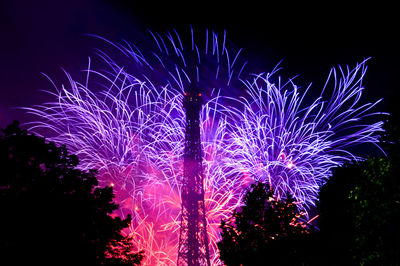 Low angle view of firework display at night