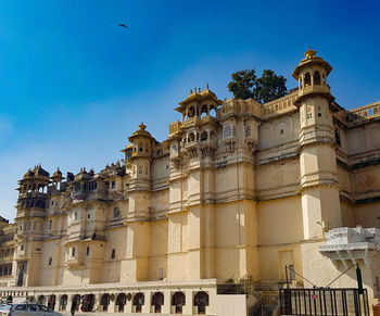 Low angle view of historical building against blue sky