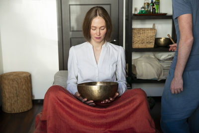 Midsection of woman sitting at home