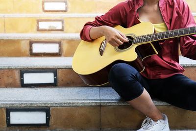 Full length of man playing guitar