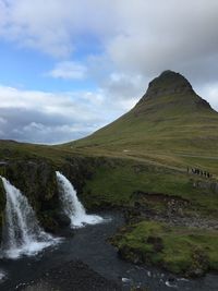 Scenic view of waterfall against sky