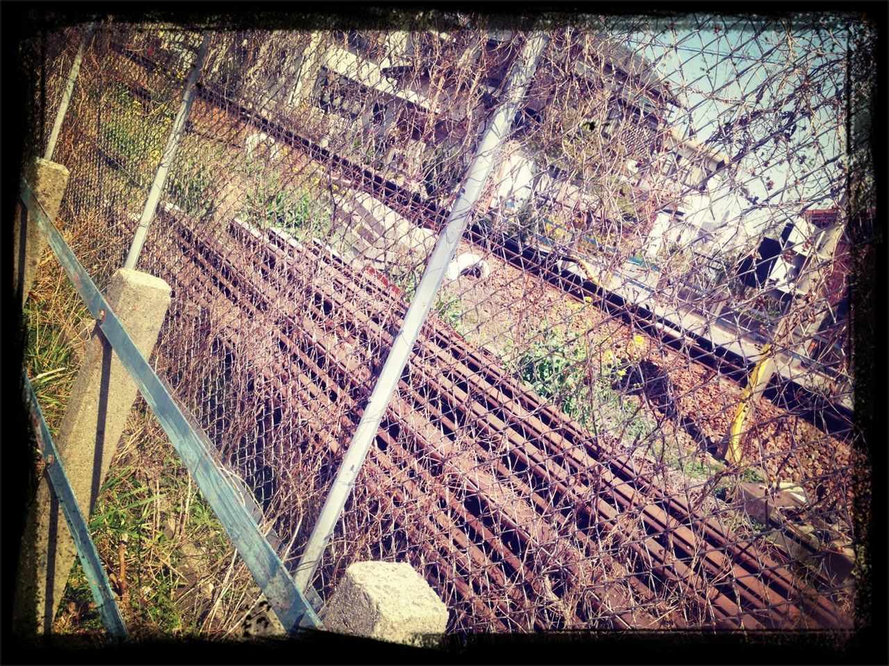 transfer print, auto post production filter, high angle view, sunlight, built structure, railing, metal, steps, fence, day, shadow, architecture, outdoors, chainlink fence, building exterior, pattern, protection, wall - building feature