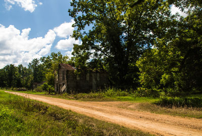 Road amidst field against sky