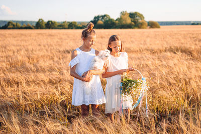 Full length of women standing on field