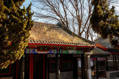 View of built structure with bare trees in foreground