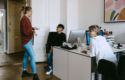 Male and female coworkers discussing in meeting at office