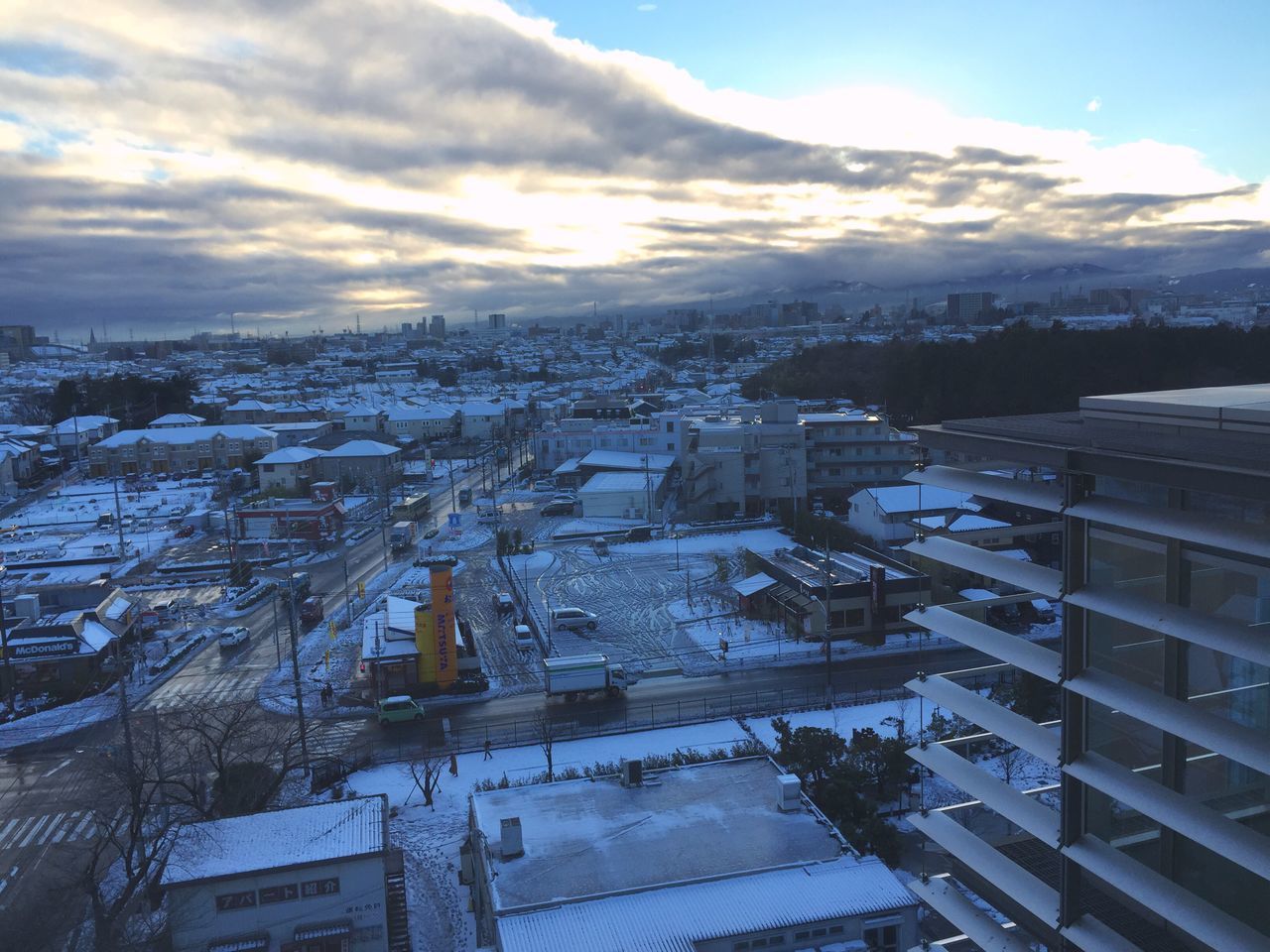 building exterior, architecture, built structure, cold temperature, winter, city, snow, cityscape, sky, high angle view, residential building, residential district, residential structure, season, cloud - sky, weather, crowded, house, sunset, town