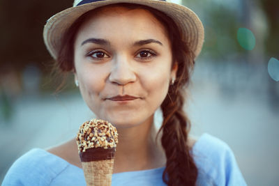 Portrait of smiling woman holding ice cream