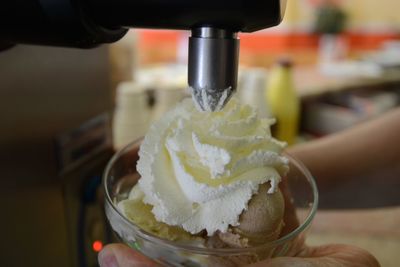 Close-up of hand holding ice cream