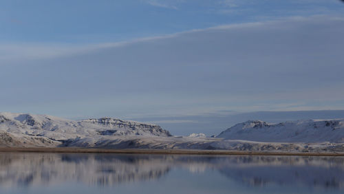 Scenic view of lake and mountains against sky