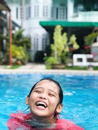 Portrait of a smiling woman swimming in pool