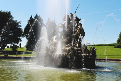 Water splashing in fountain against sky