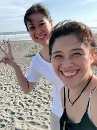 Portrait of smiling young women at beach