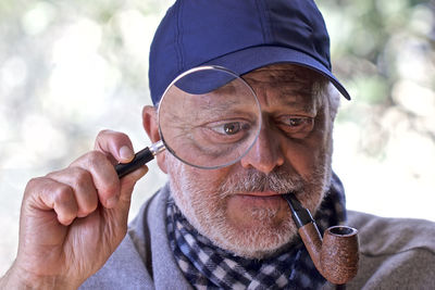 Portrait of man holding eyeglasses