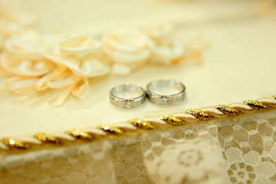 Close-up of wedding rings on table