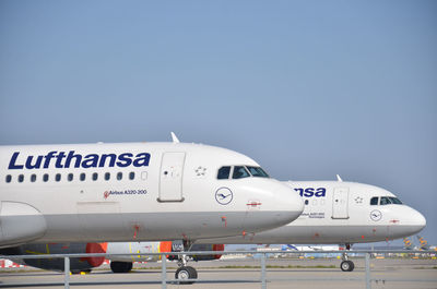 Airplane on airport runway against clear sky