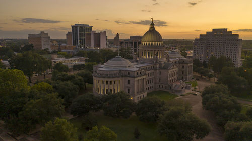 Buildings in city at sunset