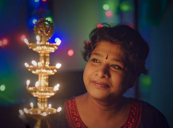 Portrait of girl in illuminated christmas tree