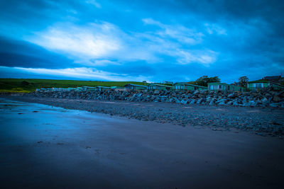 Scenic view of beach against blue sky