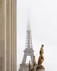 Low angle view of statue in city against sky