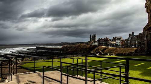 Scenic view of sea and city against sky