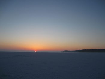 Scenic view of sea against clear sky during sunset