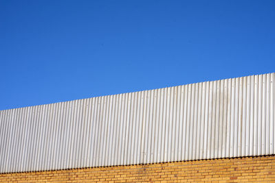 Low angle view of building against clear blue sky