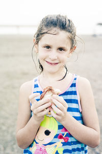 Portrait of cute girl standing at beach