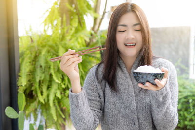 Young woman holding ice cream cone