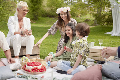 Family having cake at picnic