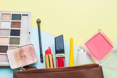 Close-up of beauty products against two tone background