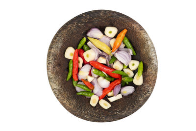High angle view of chopped vegetables in bowl against white background