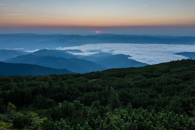 Scenic view of mountains against sky at sunset