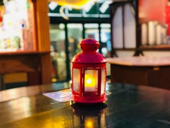 Close-up of illuminated lantern on table