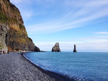 Scenic view of rocks in sea against sky